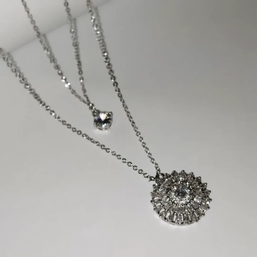 Silver-toned necklace featuring two distinct pendants