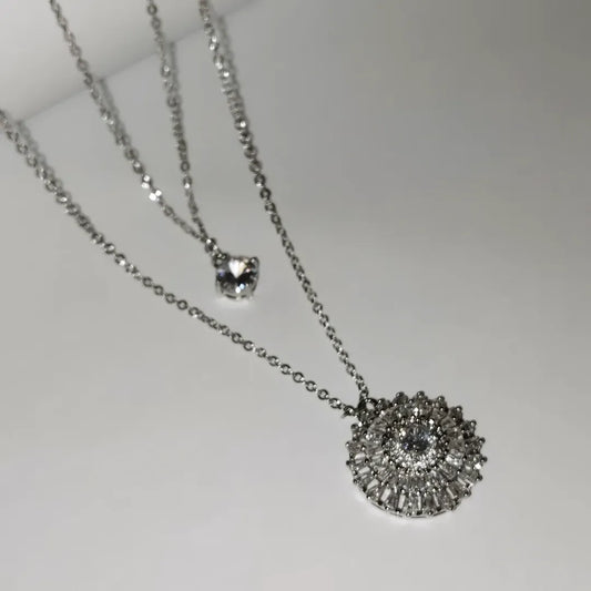 Silver-toned necklace featuring two distinct pendants